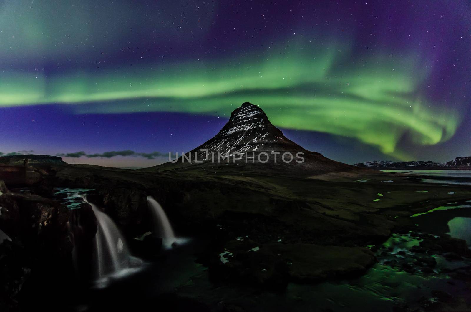 Aurora or northern lights next to Kirkjufell mountain in Iceland. Nature put on a light and dance show for us. We sat there in awe the whole time.