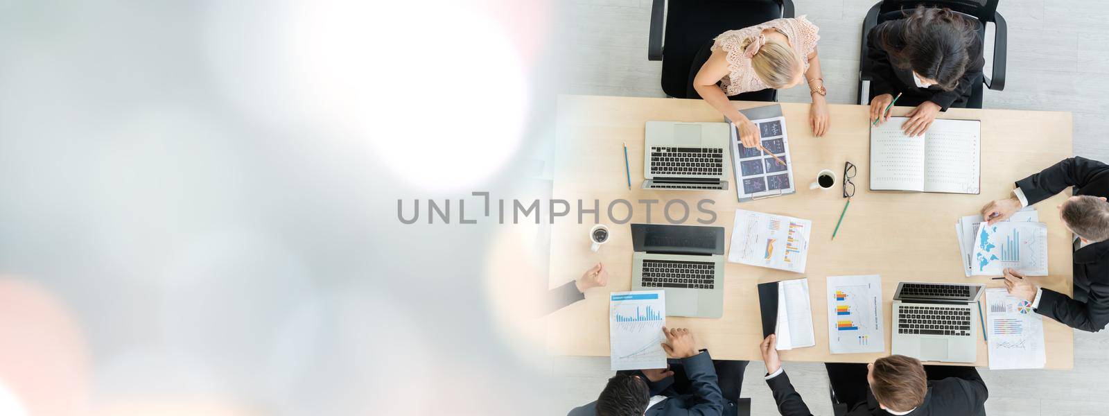 Business people group meeting shot from top widen view in office . Profession businesswomen, businessmen and office workers working in team conference with project planning document on meeting table .