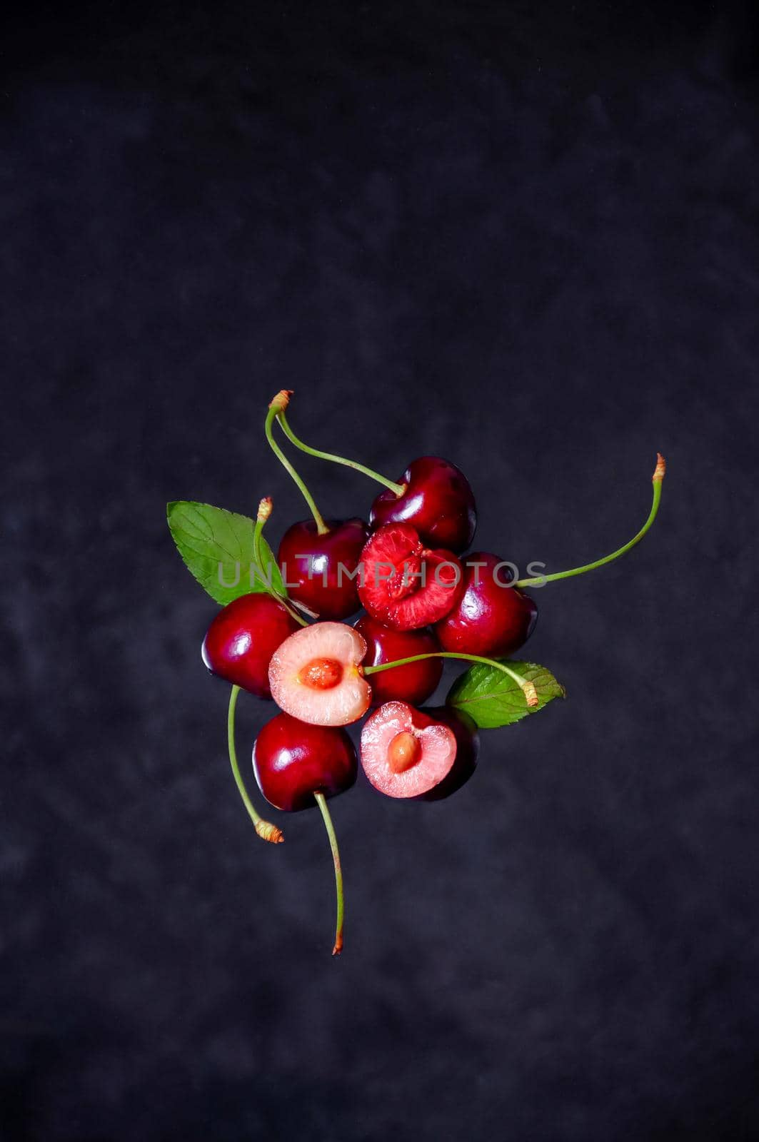 Close up Composition of Cherries Flying in the air on Dark Background by Svetlana_Belozerova