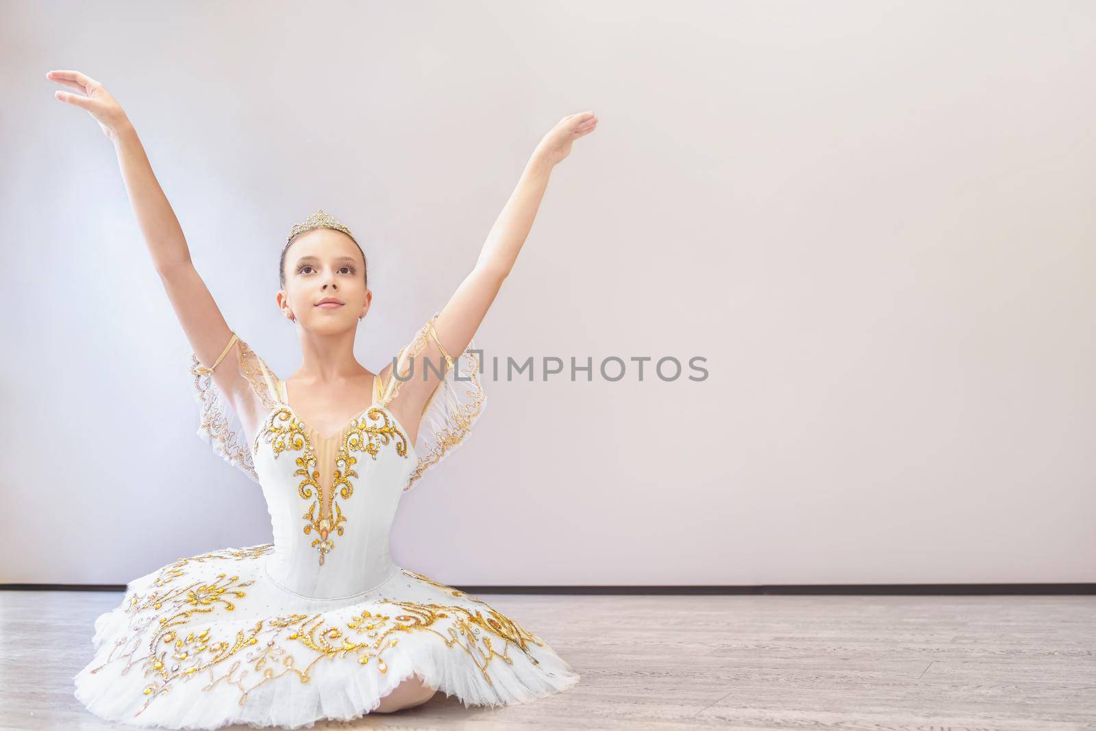 attractive young ballet dancer acting out. beautiful ballerina sitting forward split by Nickstock