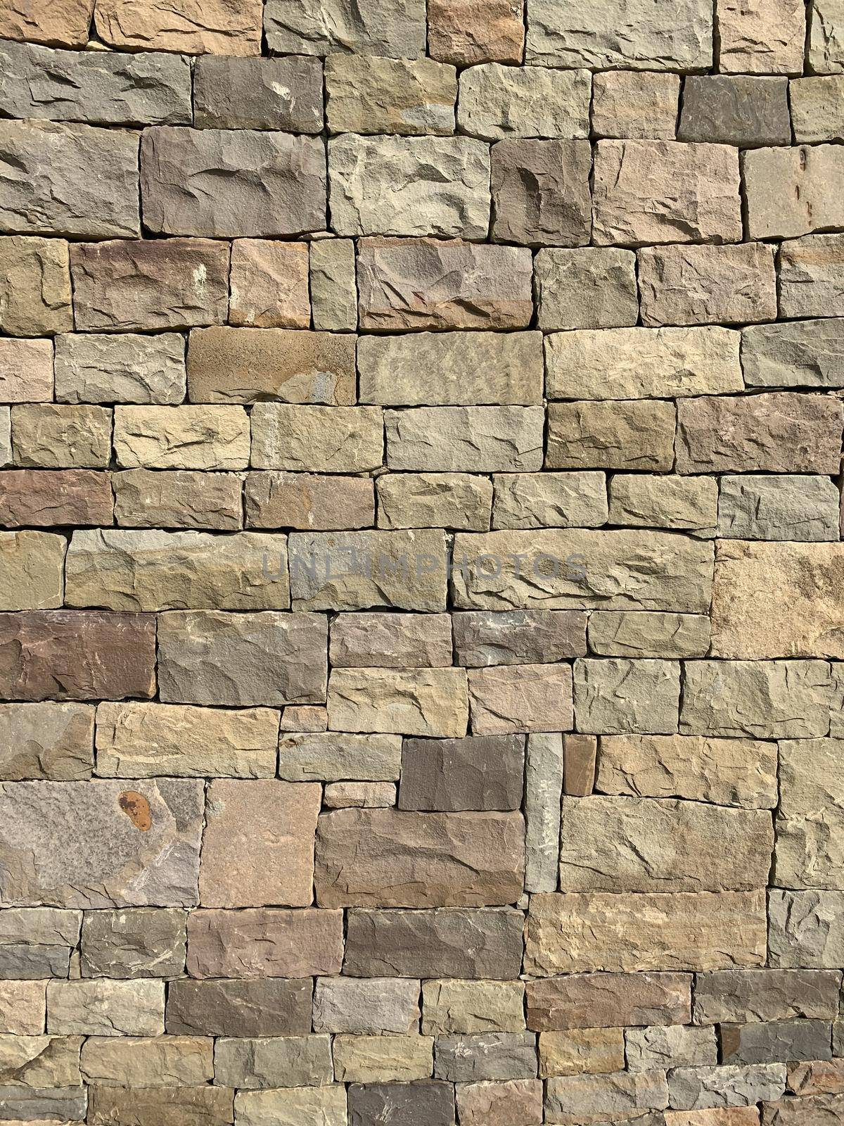 vertical photo wall natural light beige stone bricks