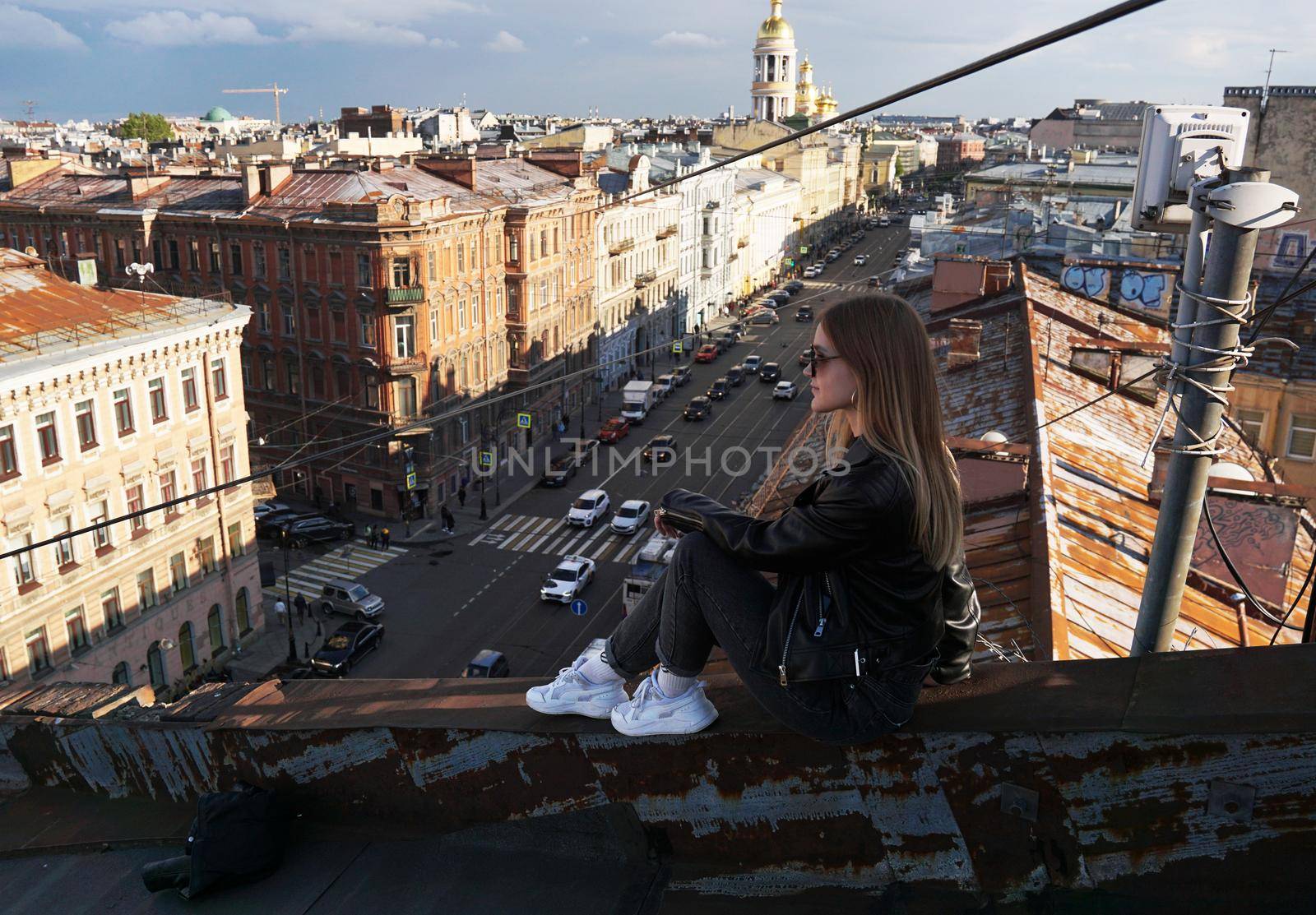 Woman is happy on the roof of Saint Petersburg, Russia. Cityscape view by natali_brill