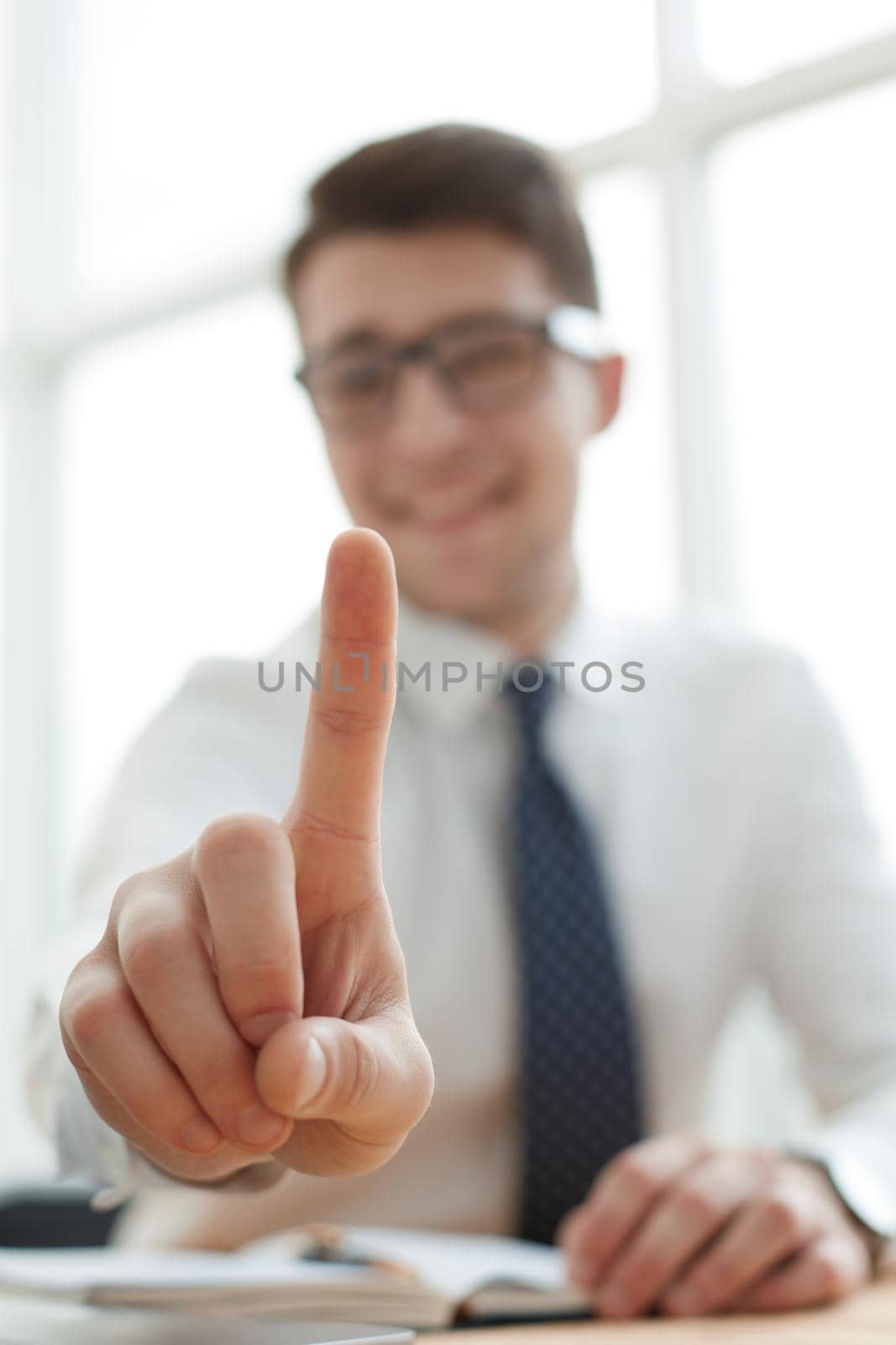 Young businessman man showing number one with fingers on hand by Prosto