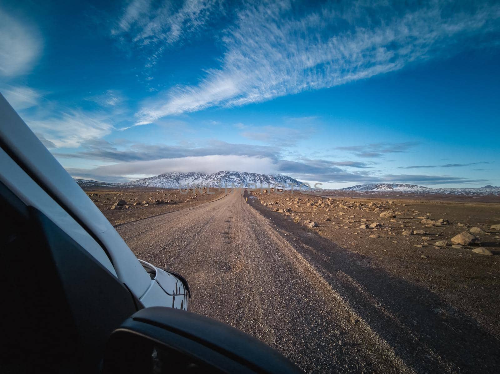 Car driving over the wild track in winter