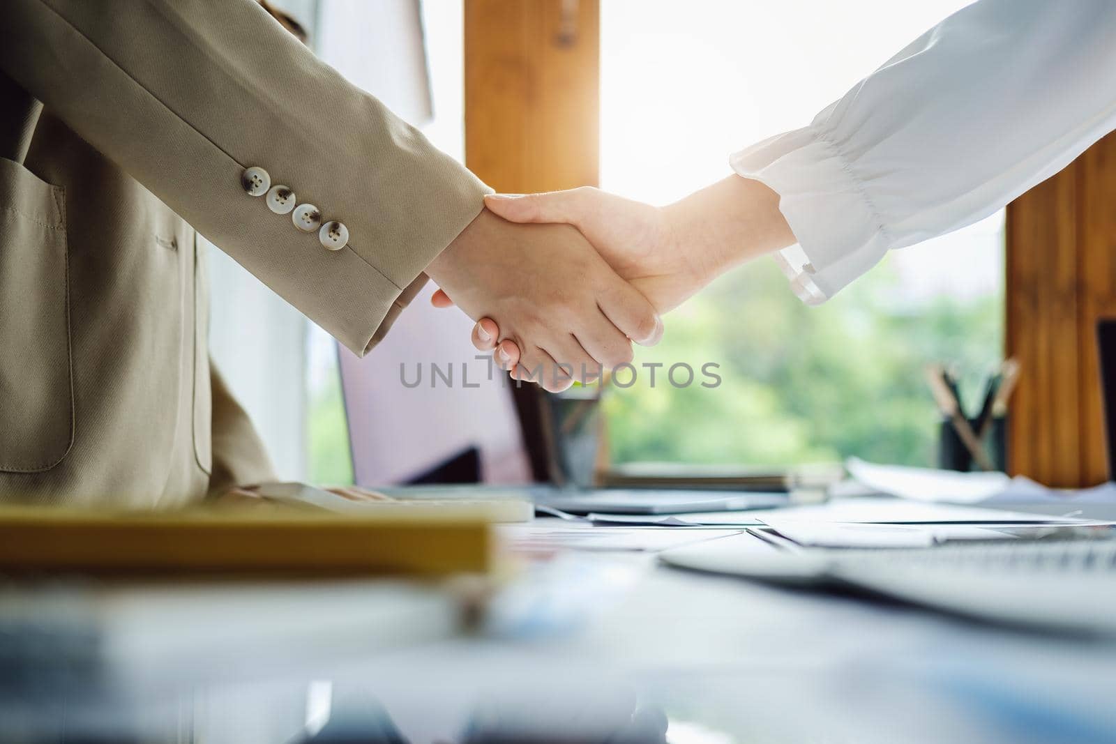 Young businesswoman collaborate with partners to increase their business investment network for Plans to improve quality next month in their office. agreement concept. by Manastrong