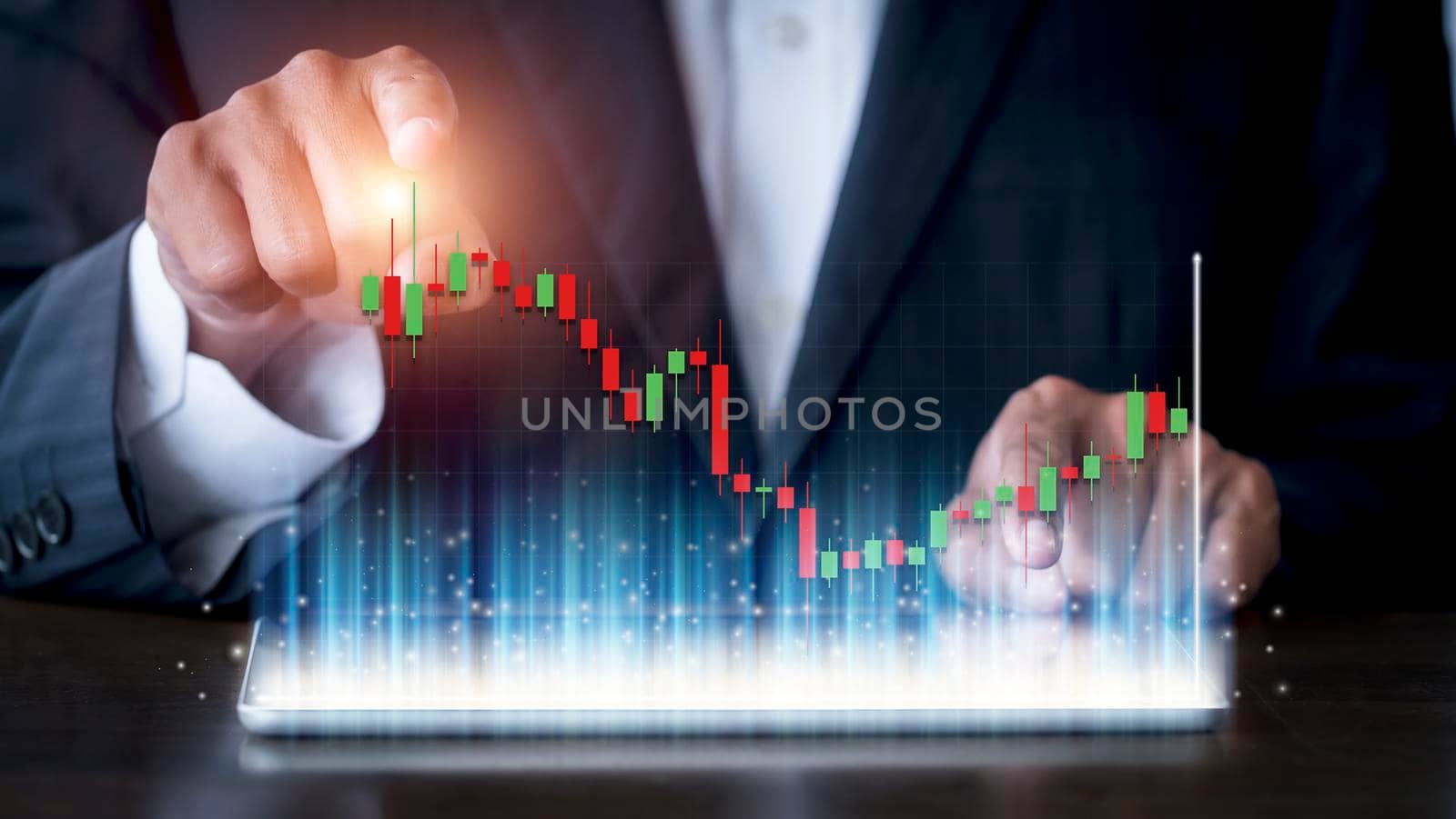 Hand of businessman use tablet analysis stock market graph growth and increase of chart positive indicators. Hand holding tablet show stock chart. Financial business stock market concept