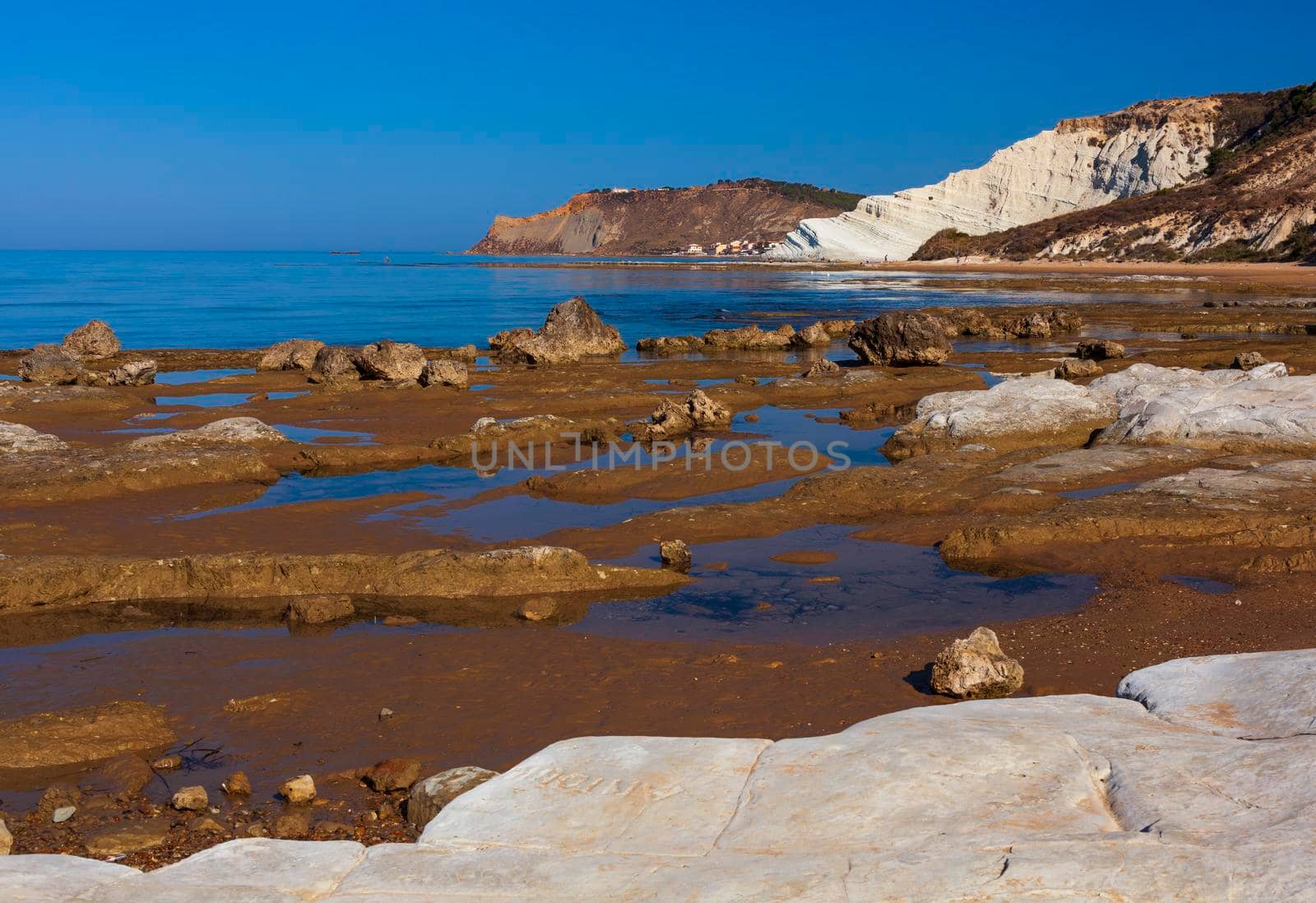 View of the limestone white cliffs with beach at the Scala dei Turchi in English Stair of the Turks or Turkish Steps near Realmonte in Agrigento province. Sicily, Italy