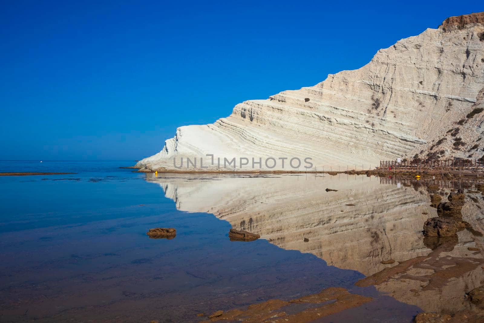 View of the limestone white cliffs with beach at the Scala dei Turchi in English Stair of the Turks or Turkish Steps near Realmonte in Agrigento province. Sicily, Italy