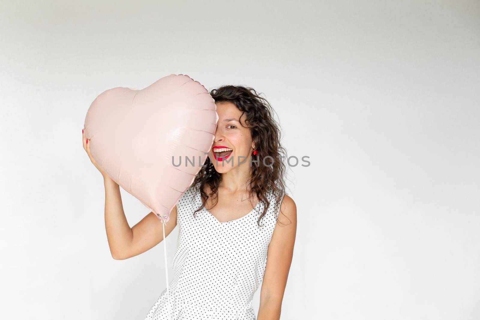 Sexy brunette girl posing with heart-shaped balloons on a white background by Try_my_best