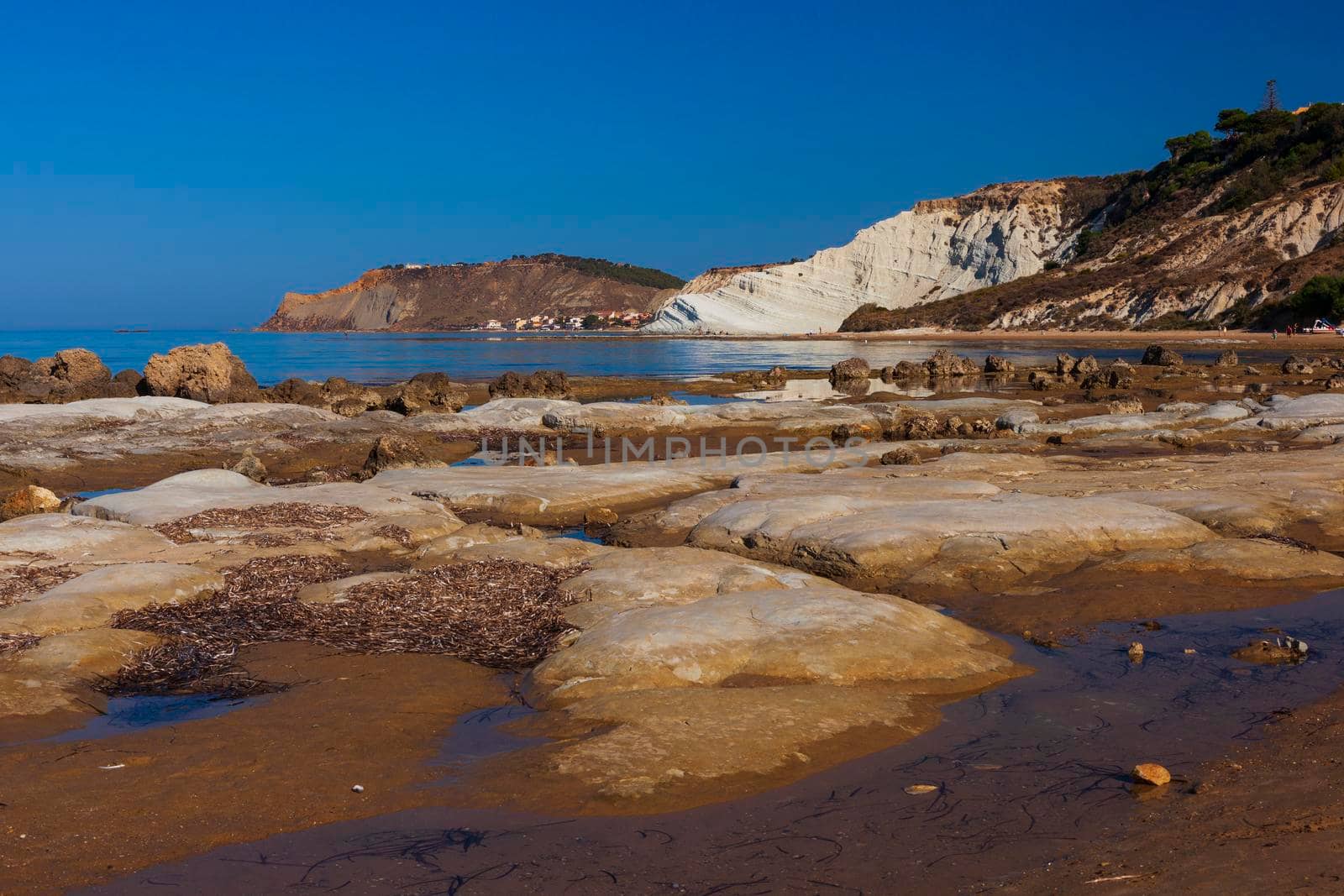 View of the limestone white cliffs with beach at the Scala dei Turchi in English Stair of the Turks or Turkish Steps near Realmonte in Agrigento province. Sicily, Italy