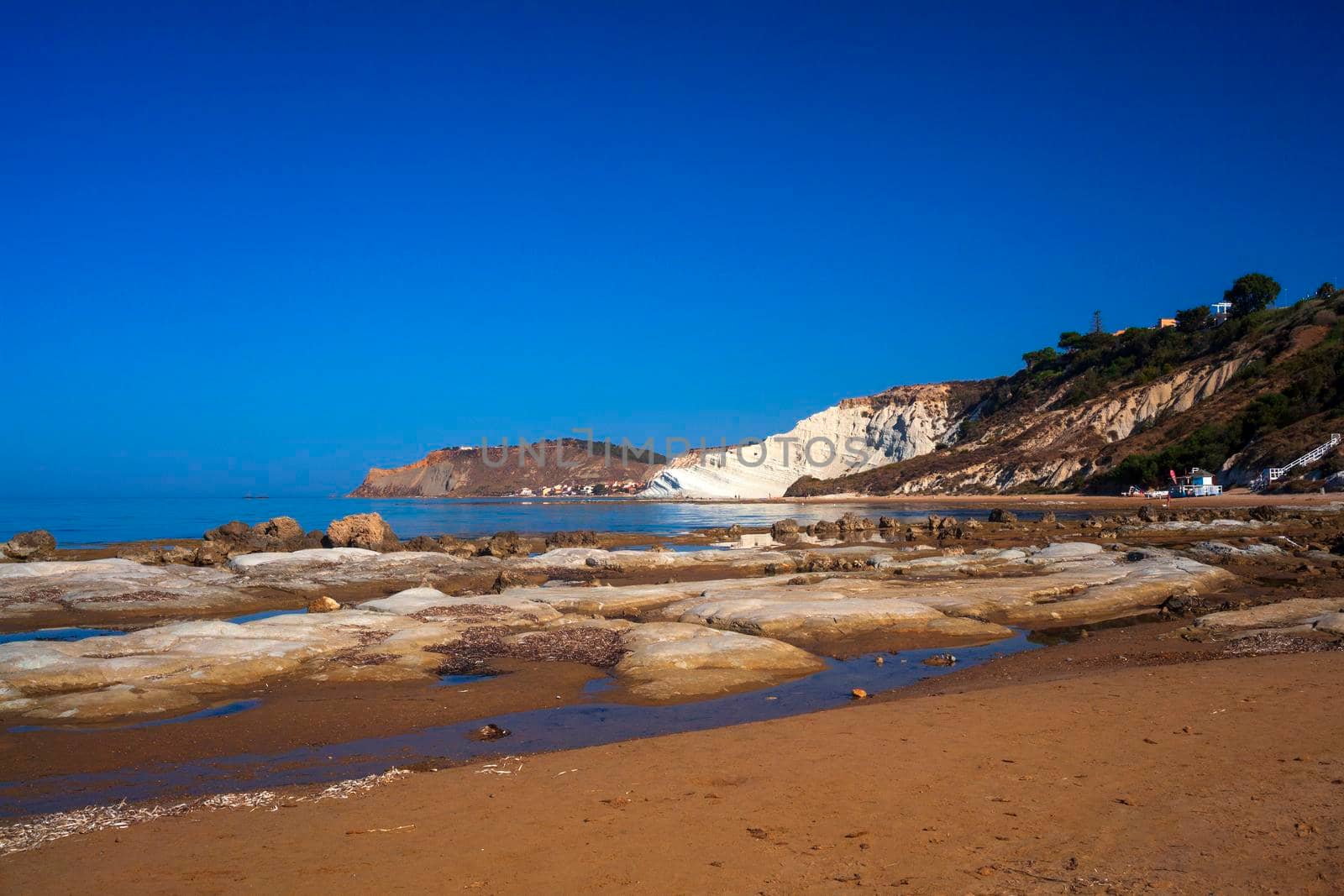 Limestone white cliffs with beach at the Scala dei Turchi, Realmonte. Agrigento by bepsimage