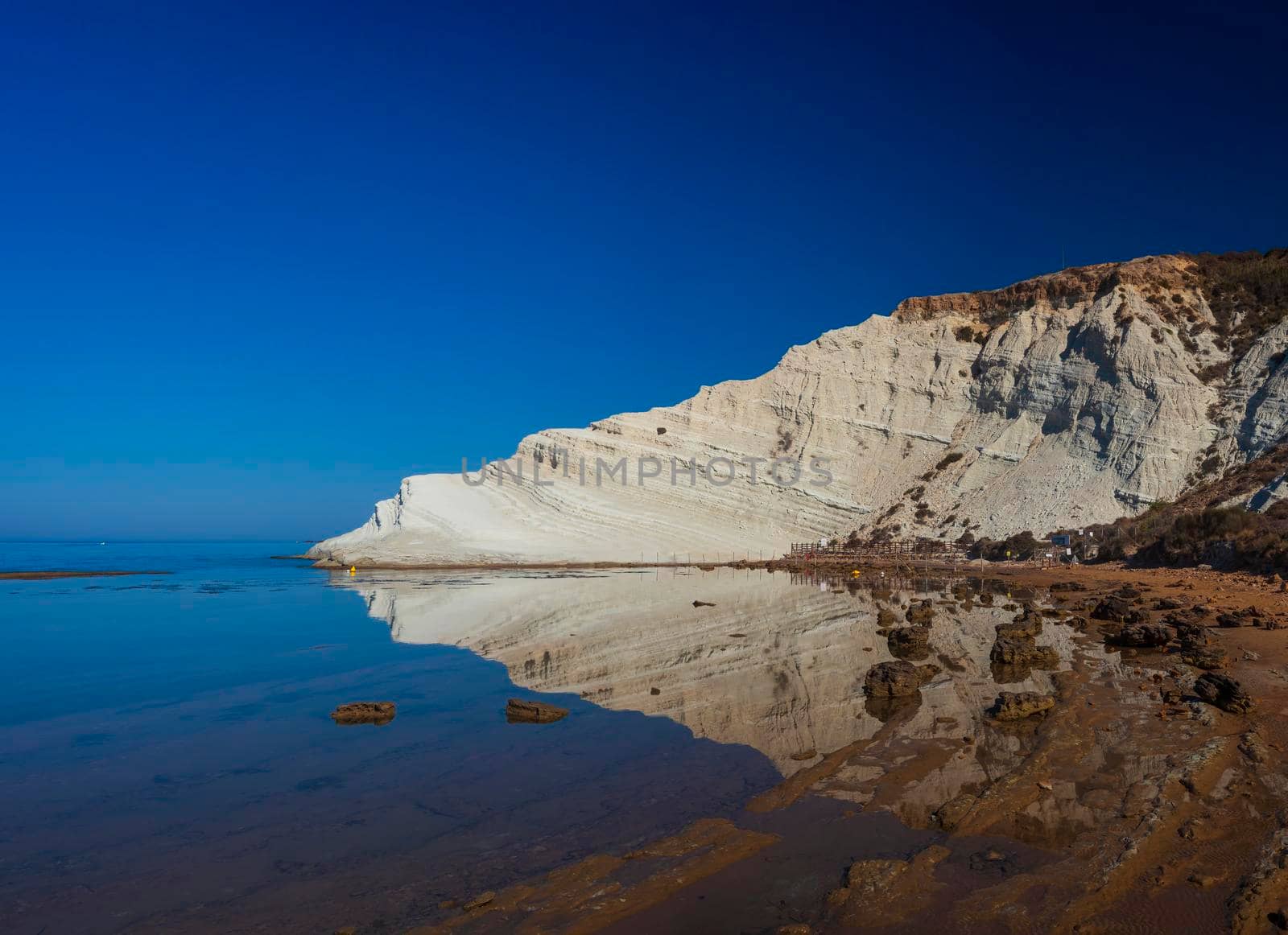 Limestone white cliffs with beach at the Scala dei Turchi, Realmonte. Agrigento by bepsimage