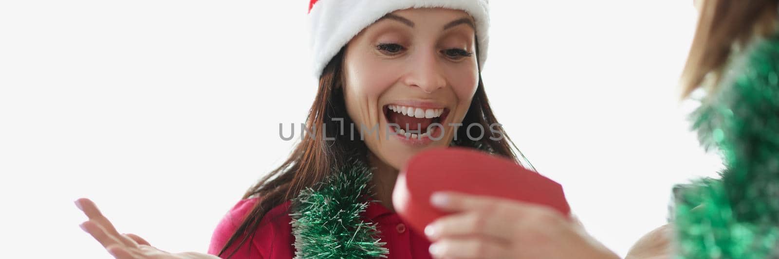Portrait of pure emotion of surprise on womans face, shocked facial expression. Scream with happiness, got present from best friend or sister. Celebrating new year, christmas, winter holiday concept