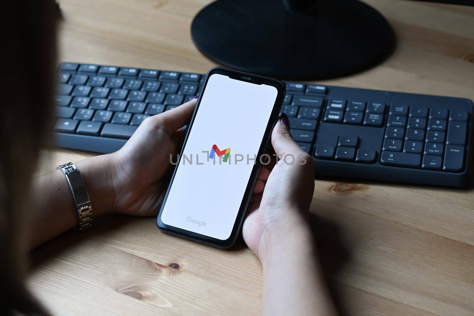 Chiang Mai, Thailand - Mar 01,2022: Woman holding iPhone 11 Pro Max with Gmail app on the screen.Gmail is a free email service provided by Google.