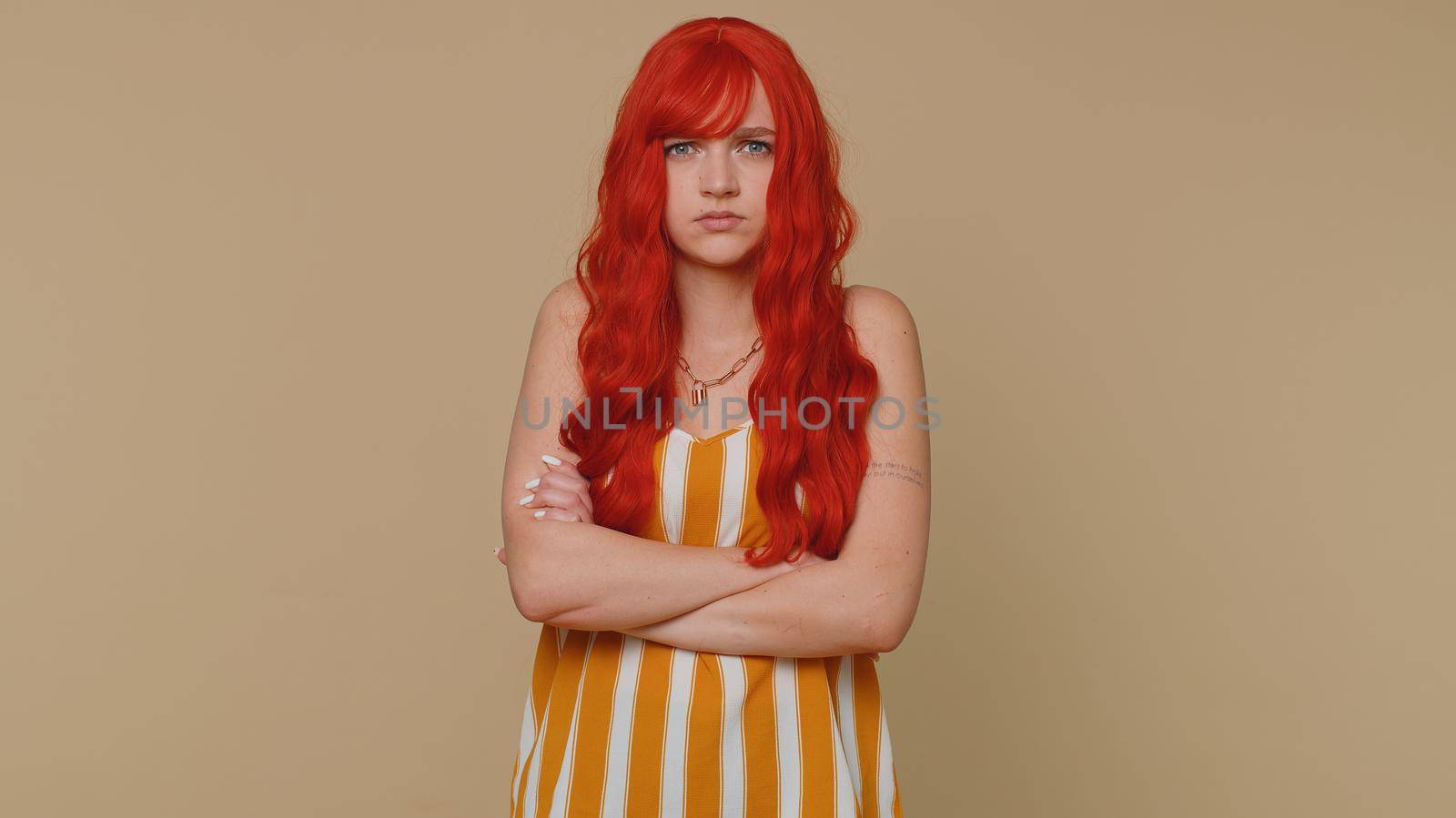 Dissatisfied woman shaking head no, asking reason of failure, expressing disbelief irritation, feeling bored, disappointed in result, bad news. Ginger girl isolated alone on beige studio background