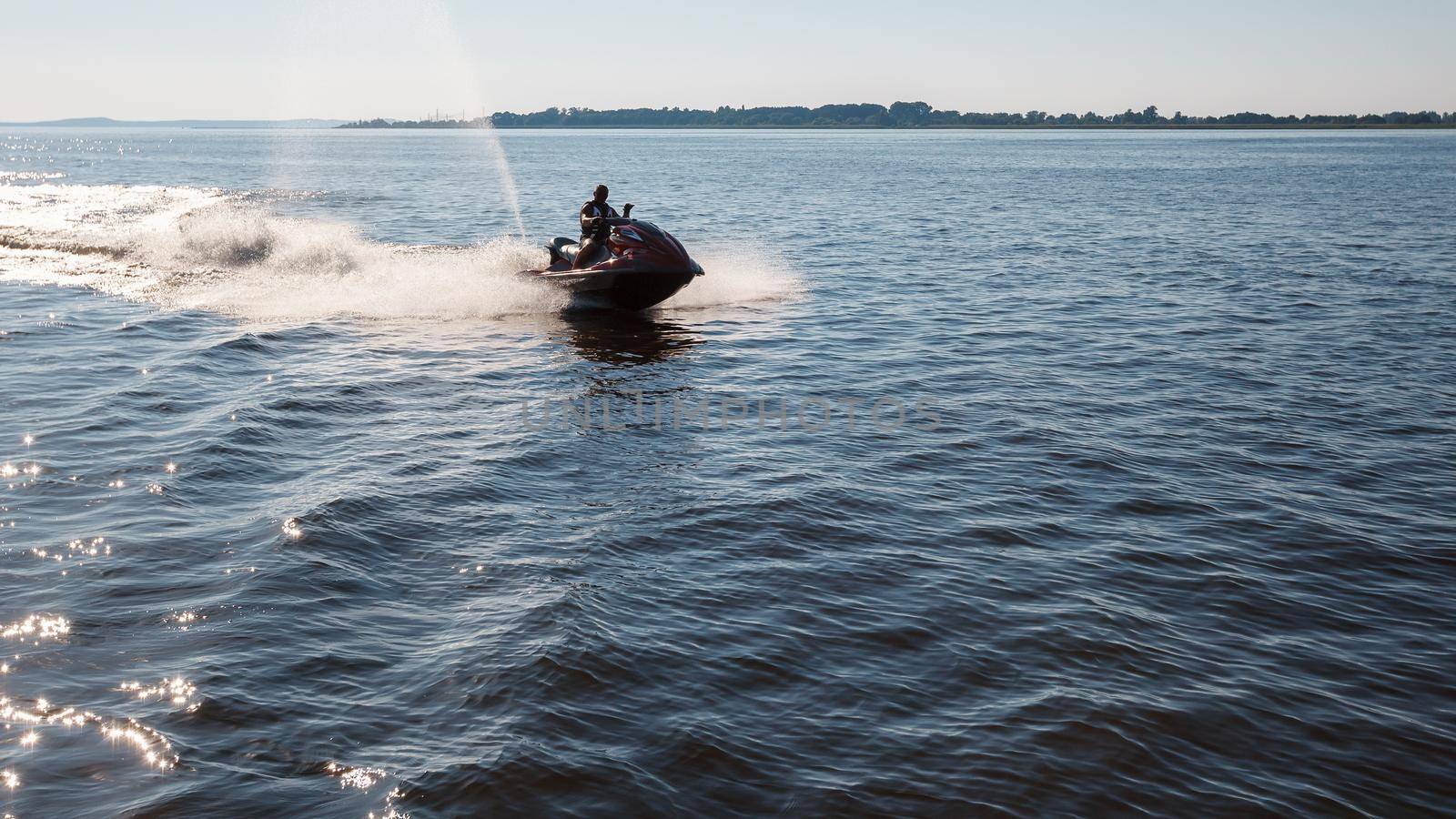 The man goes for a drive on a water motorcycle. by Lincikas