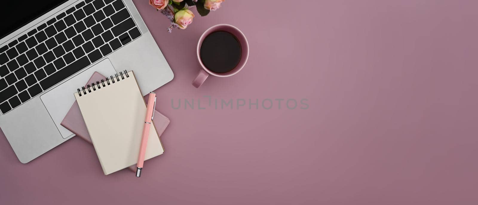 Flat lay laptop computer, coffee cup and notebook on pink background with copy space. by prathanchorruangsak