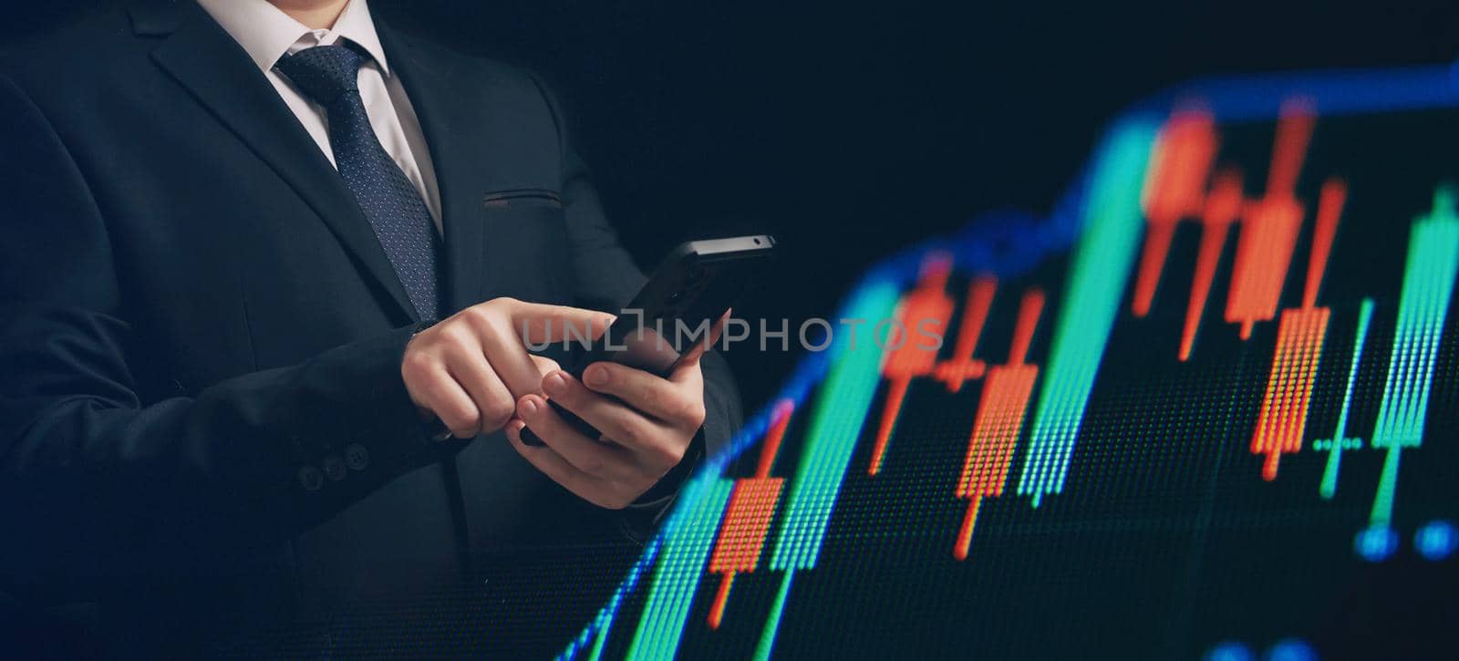 Man using smartphone with graphs analysis candle line and foreign currency rate on bokeh colors light. Manager analyzing investment statistics and indicators on dashboard for trading products. by Maximusnd