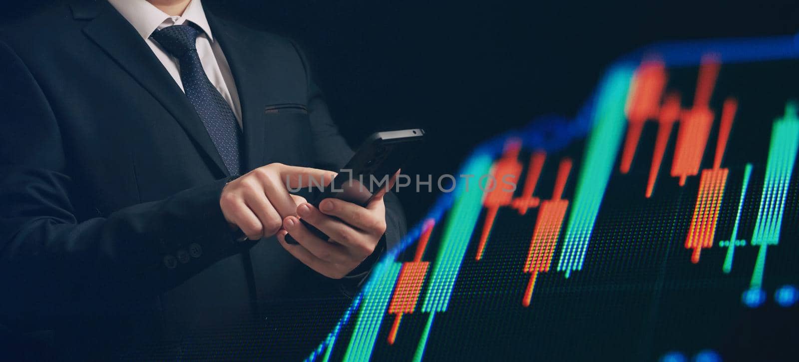 Man using smartphone with graphs analysis candle line and foreign currency rate on bokeh colors light. Manager analyzing investment statistics and indicators on dashboard for trading products.