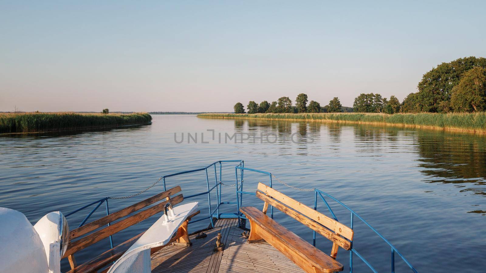 Landscape with boat front and river delta on a warm summer evening. by Lincikas