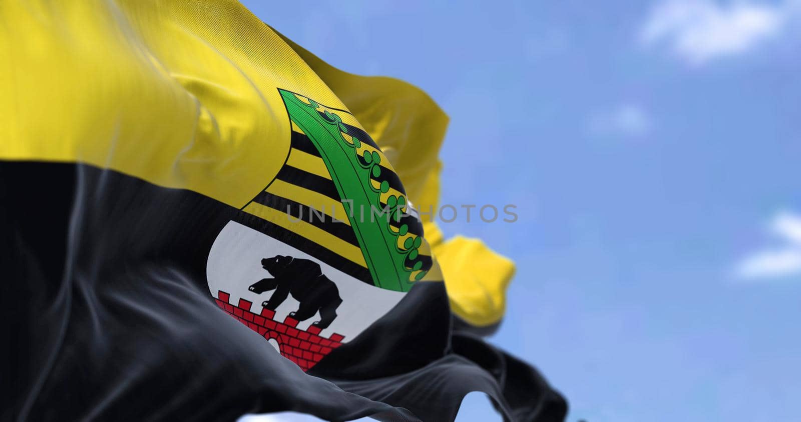 The flag of Saxony-Anhalt waving in the wind on a clear day by rarrarorro