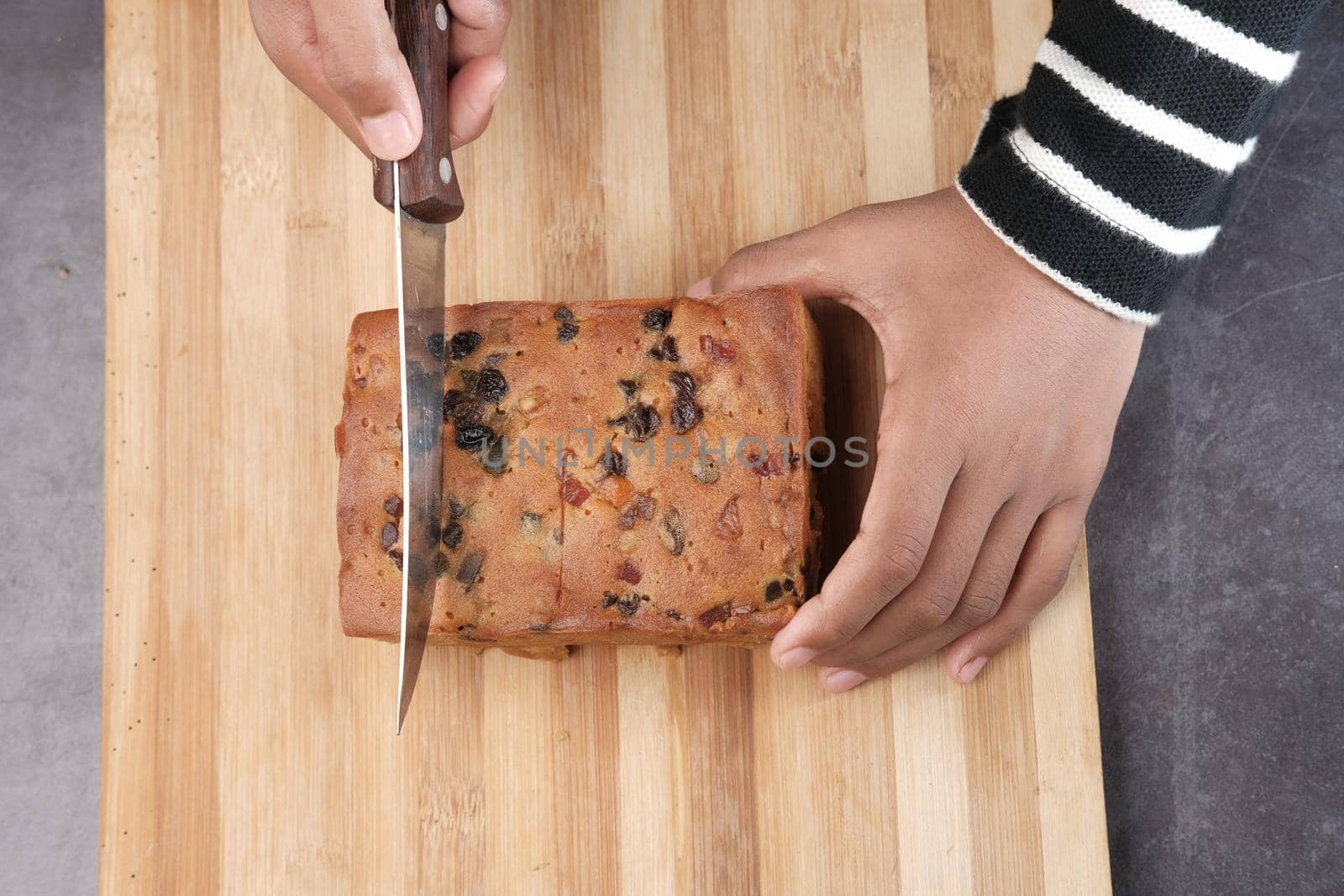 slice of bakery fruit cake on chopping board ,