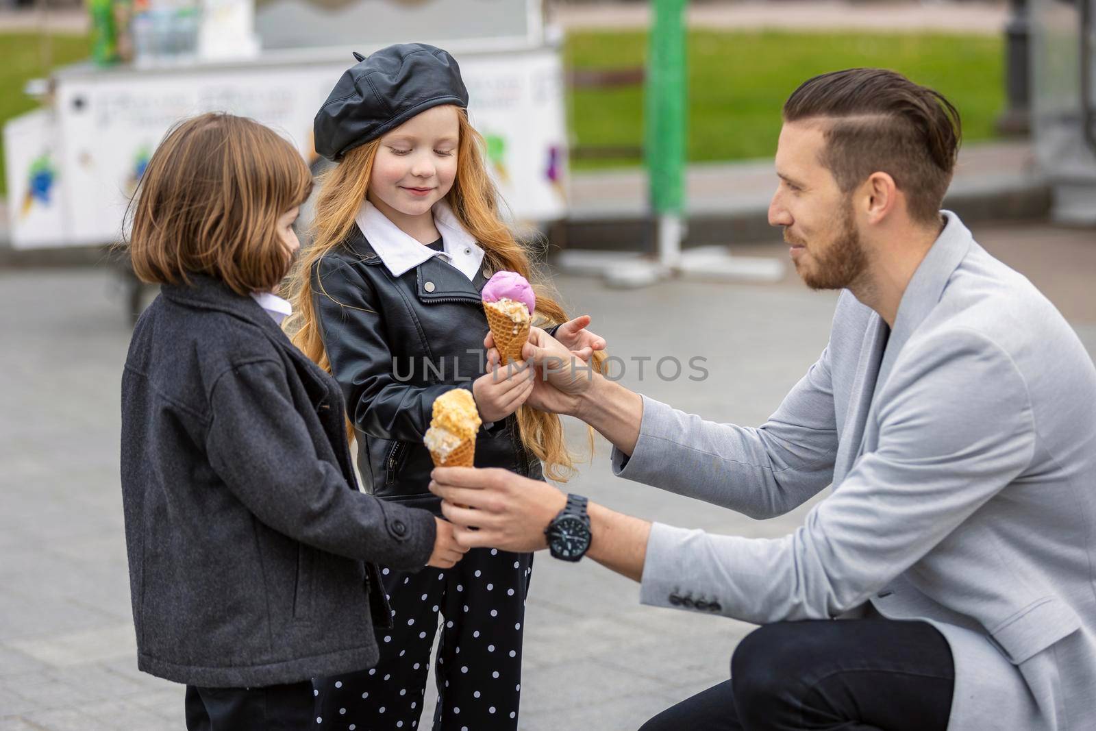 Man gives ice cream to children on the street