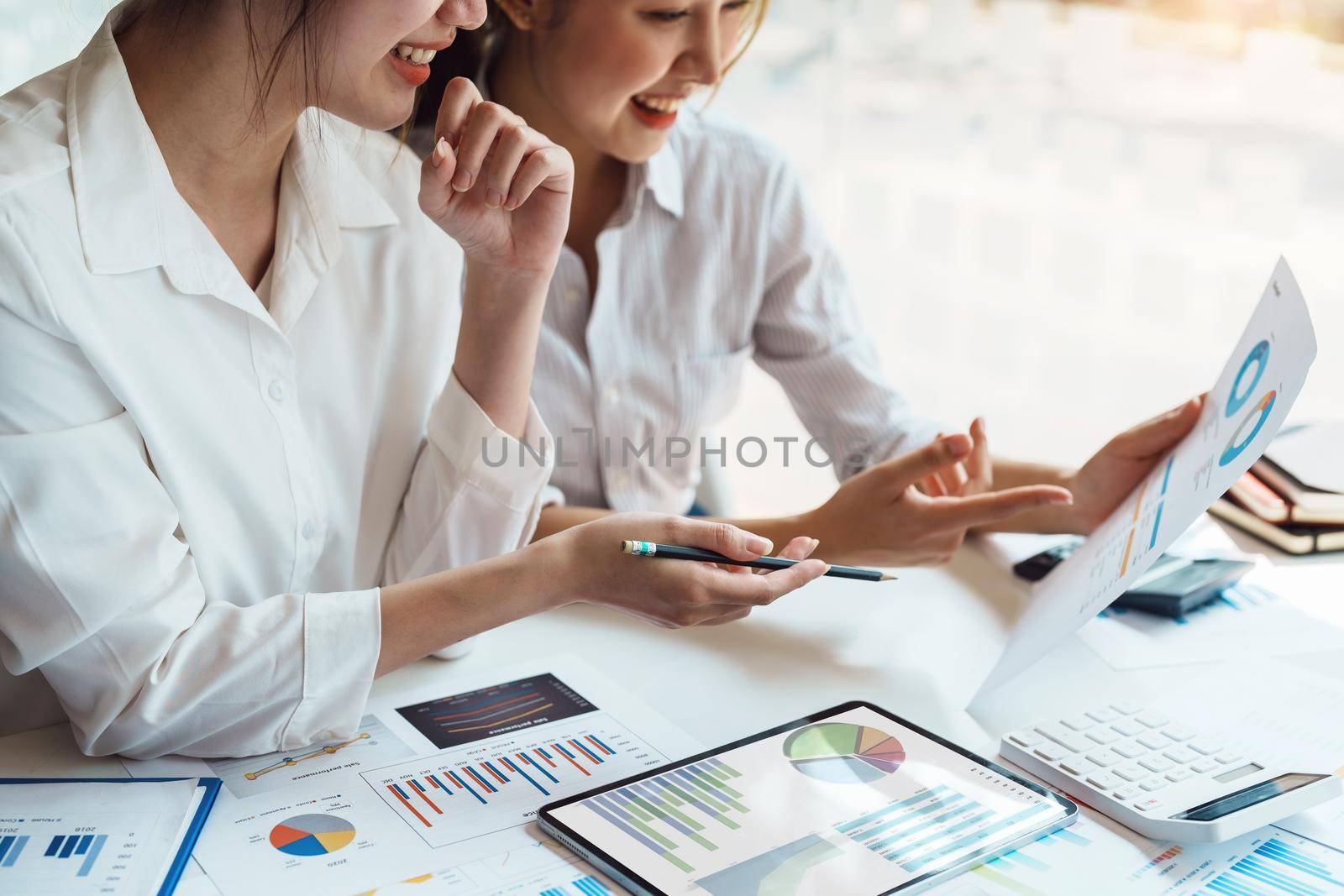 teamwork concept, consulting, economist holding budget papers finance and investment Discuss and plan finances with a female marketer adviser in the conference room by Manastrong