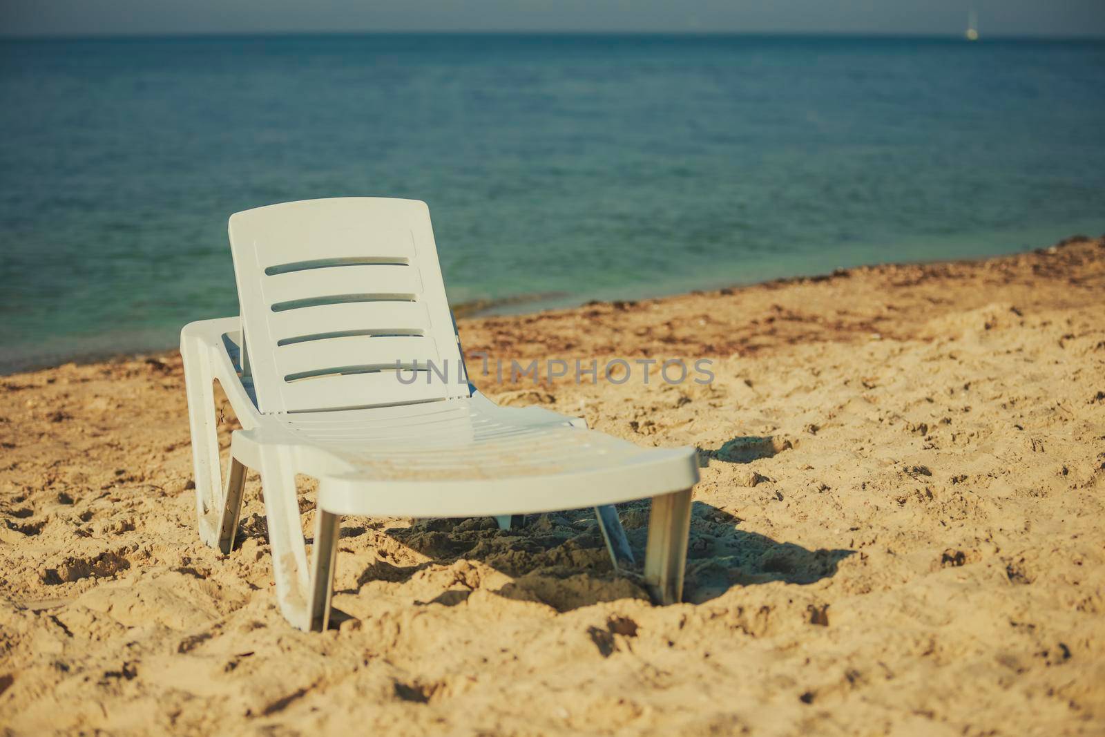 white lounger by the sea
