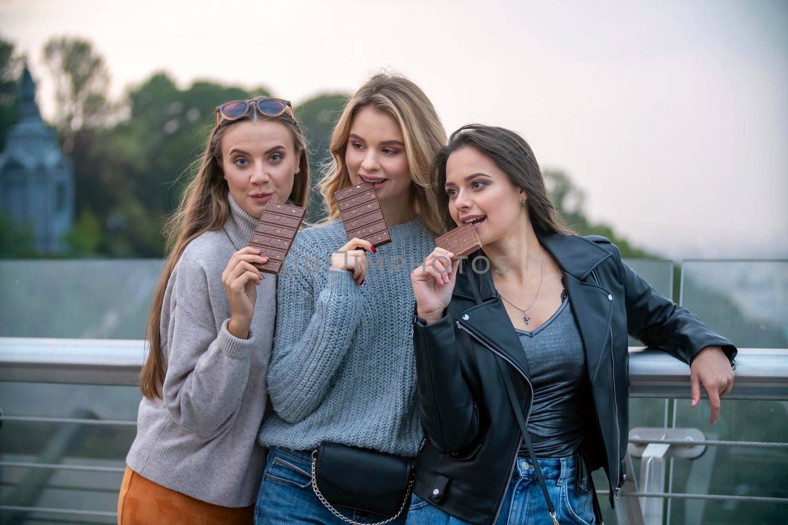 three girls eating chocolate with nuts