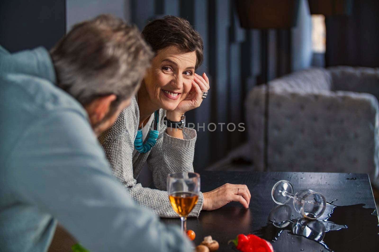 aged couple in the kitchen talking about something by zokov