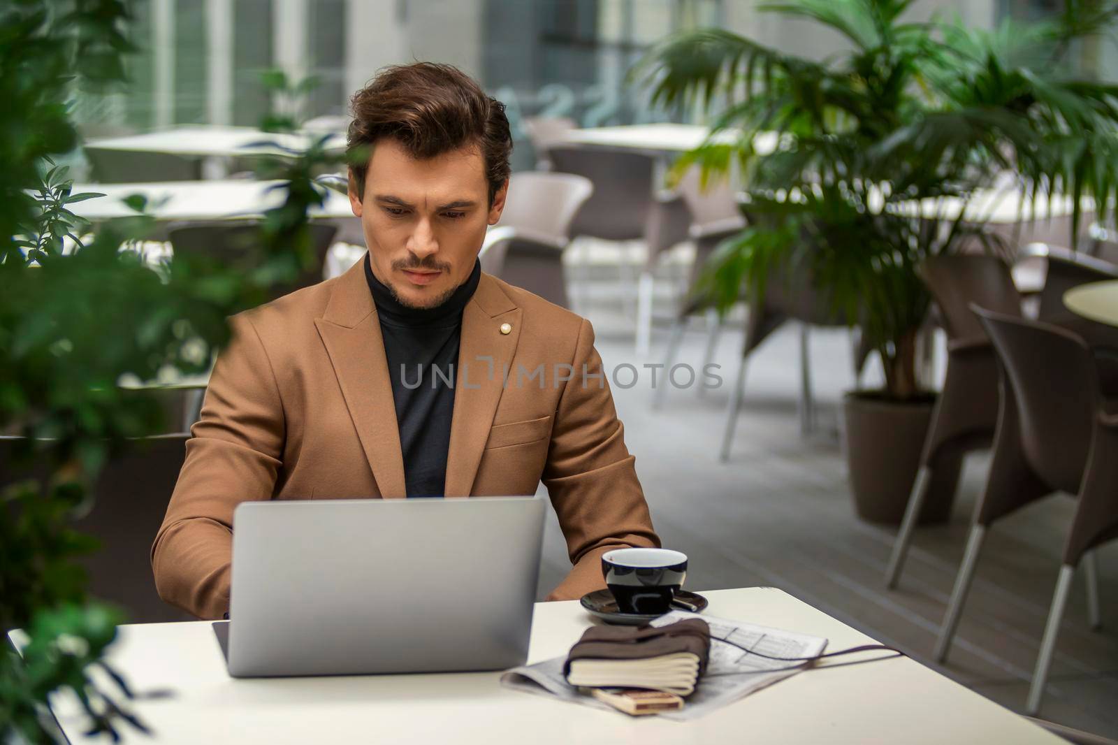 businessman sitting at the table and looking at the computer