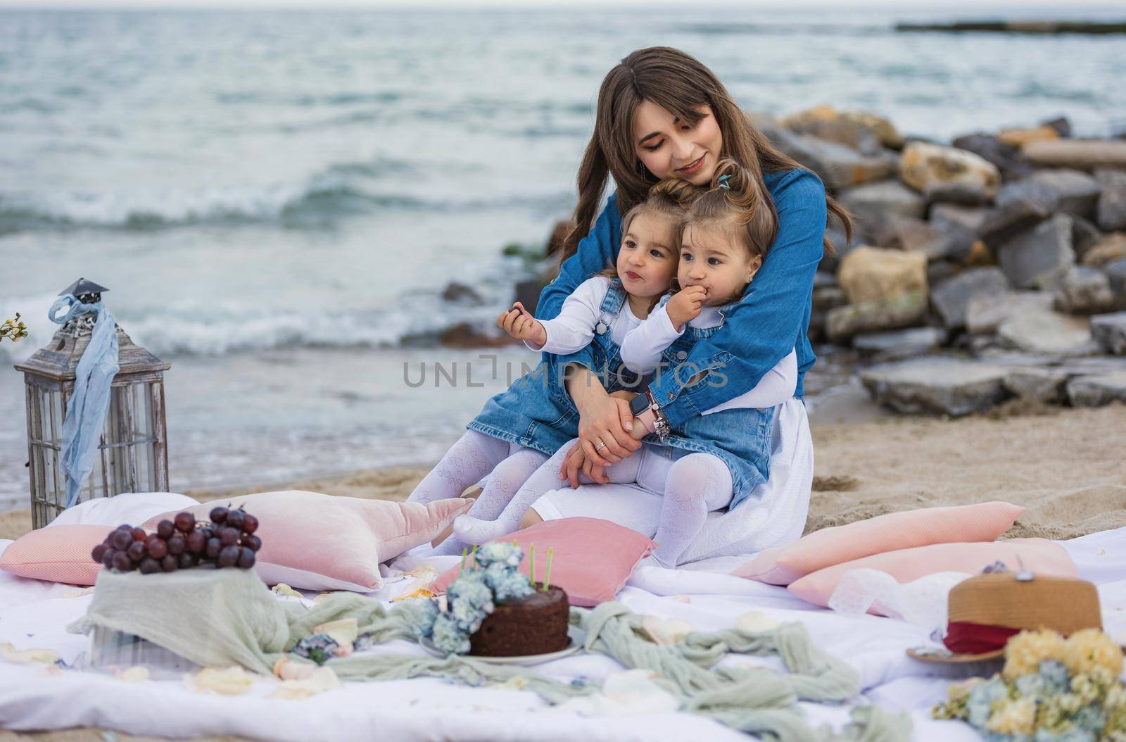 mother with children relaxing on the beach