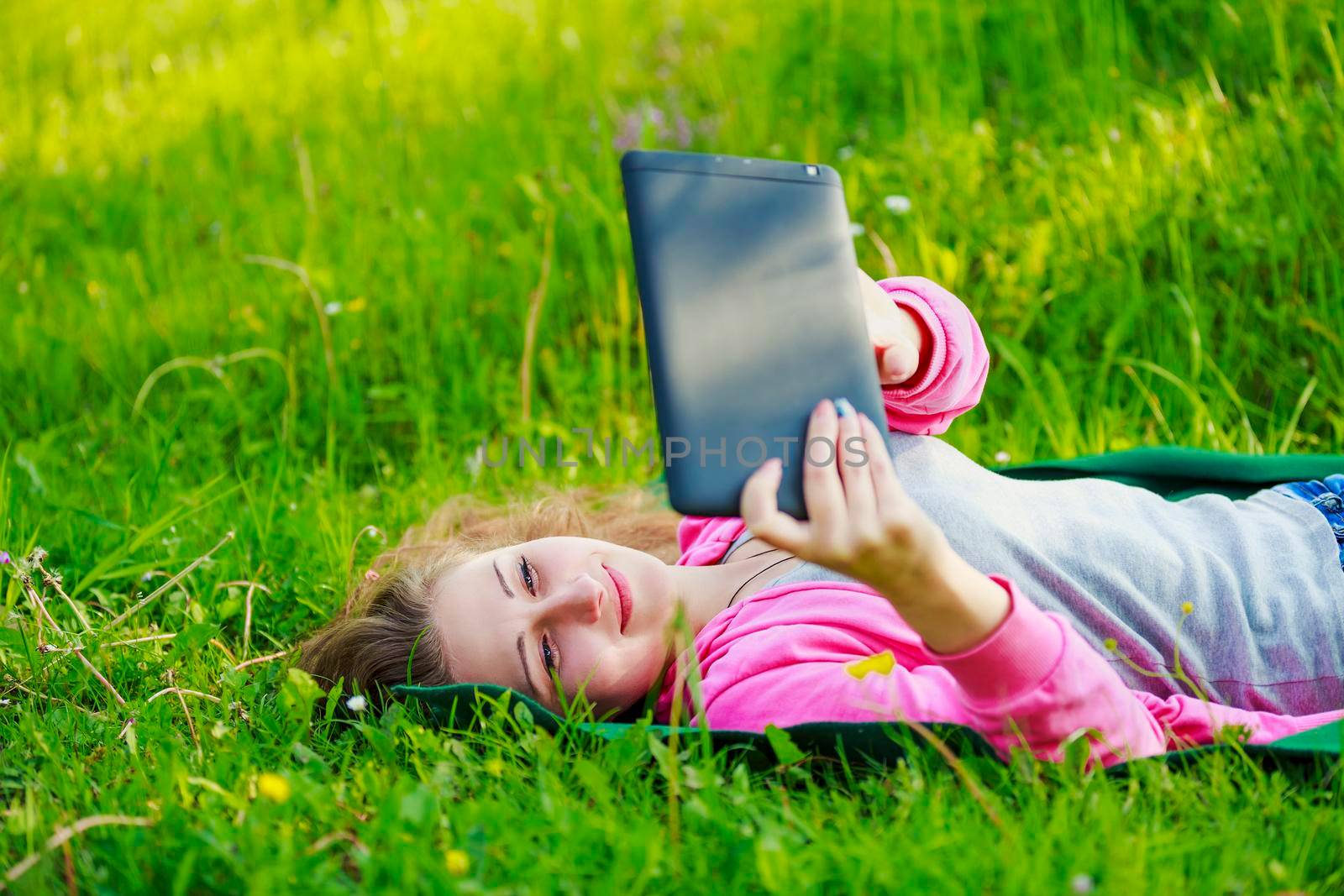 portrait of a girl with a tablet in nature