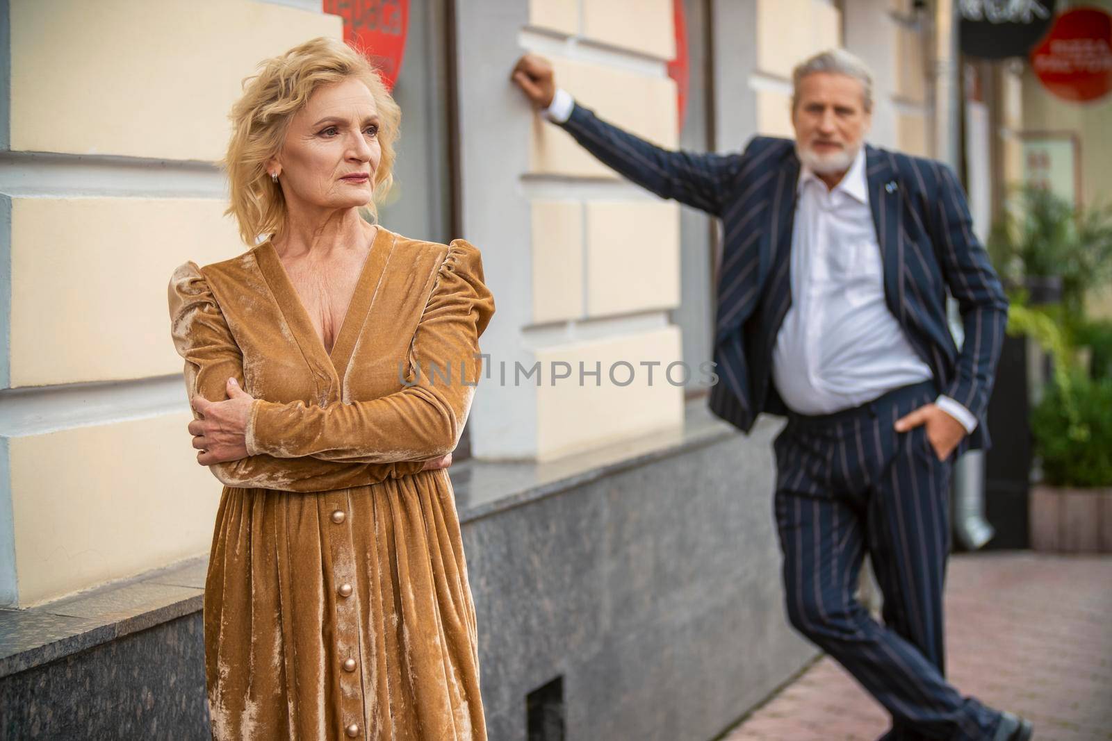 aged couple walking in the city by zokov