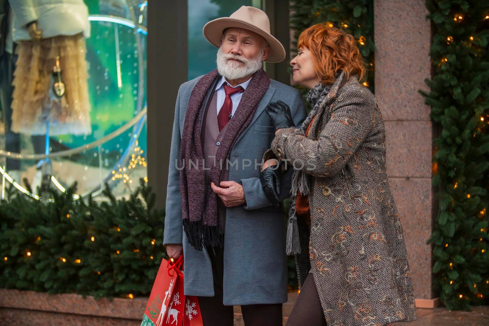 elderly couple on the background of a shop window