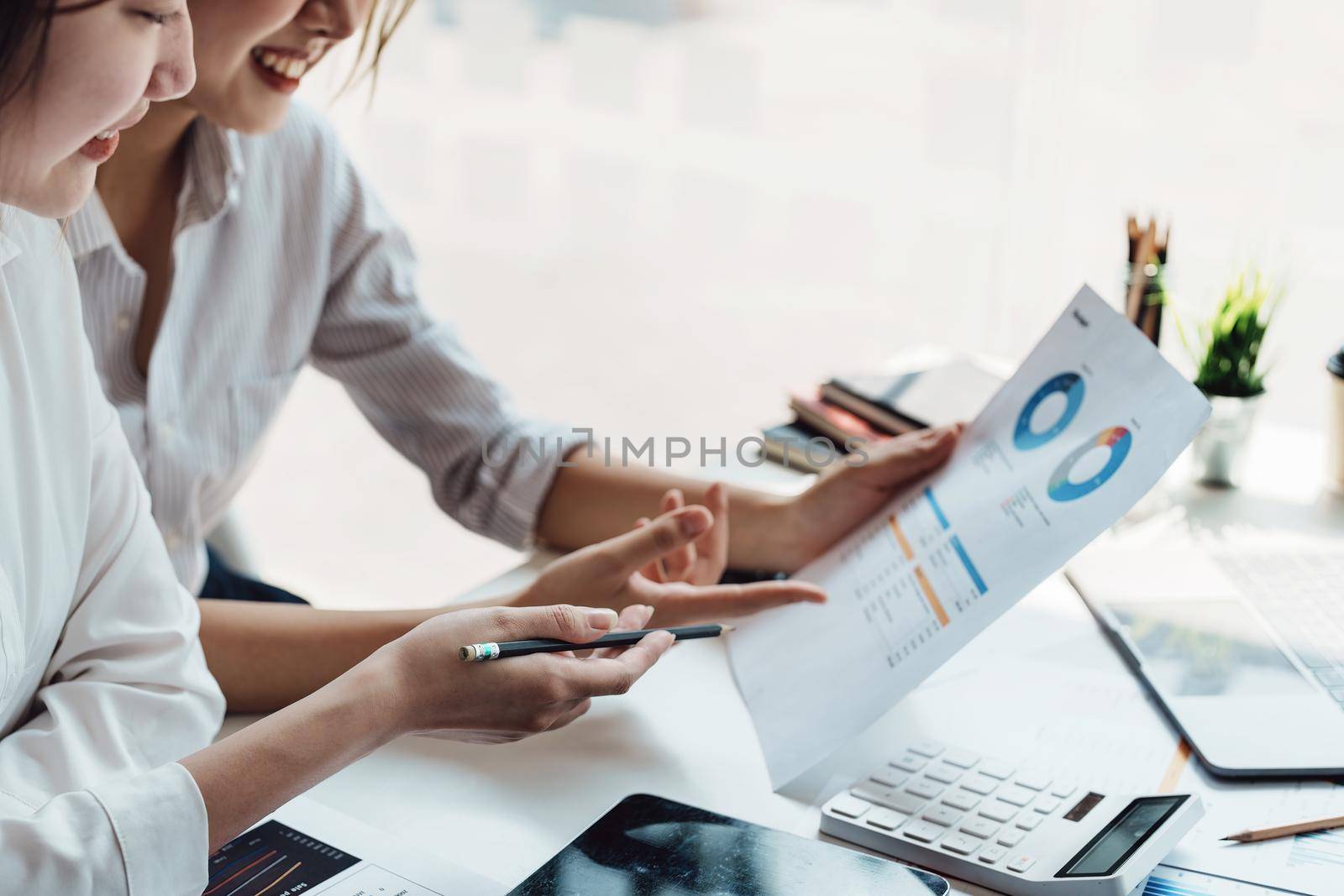 teamwork concept, consulting, economist holding budget papers finance and investment Discuss and plan finances with a female marketer adviser in the conference room by Manastrong