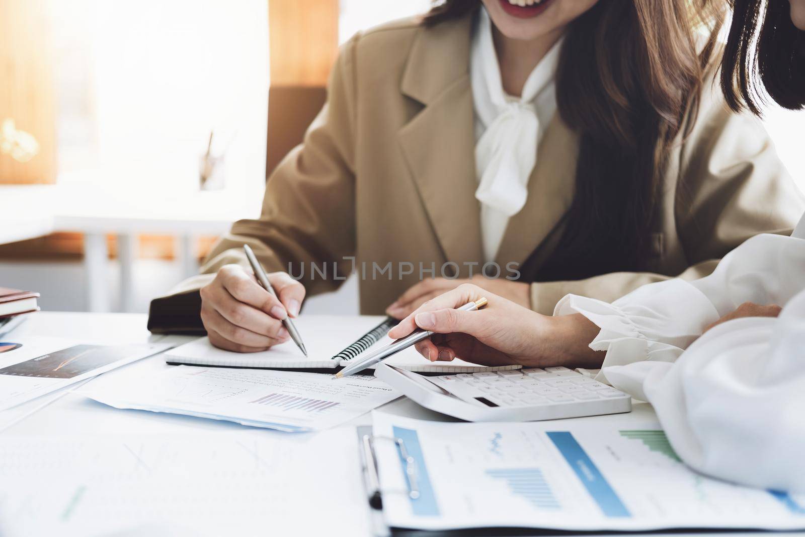 Negotiation, Analysis, Discussion, Asian woman economist and marketer pointing to a financial data sheet to plan investments to prevent risks and losses for the company by Manastrong