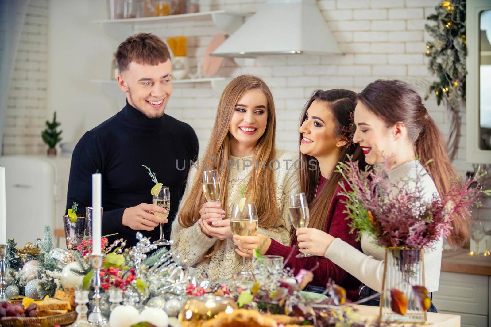 guy with girls drinking champagne standing at the table