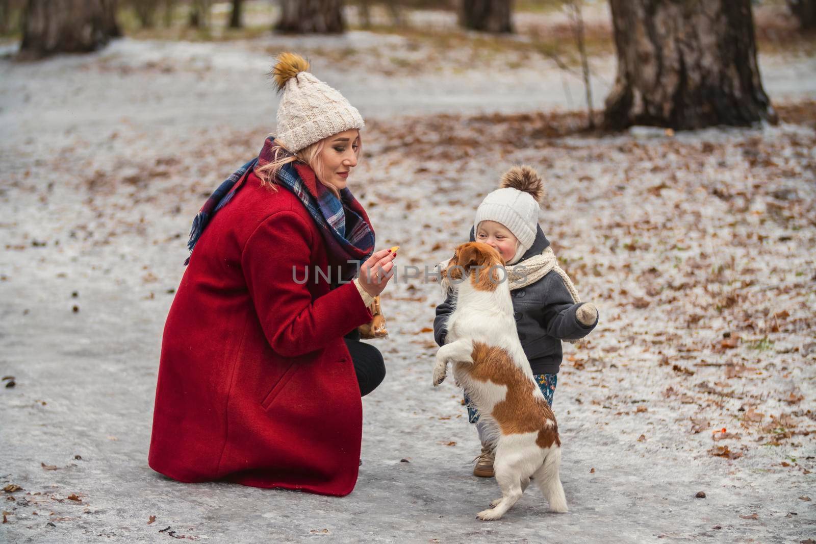 mom with daughter and dog in winter park