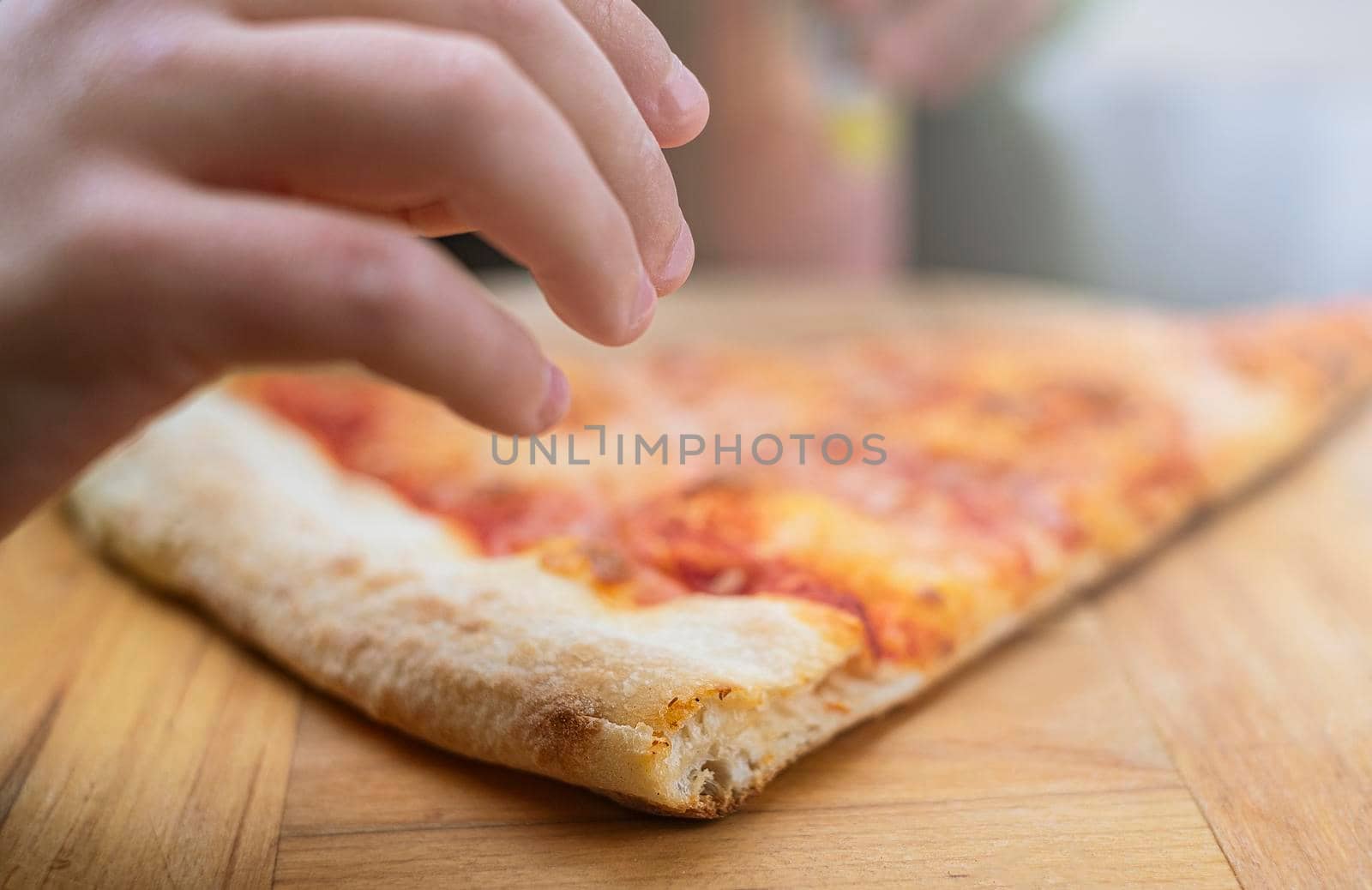 a piece of pizza on wooden background in outdoor. Lifestyle