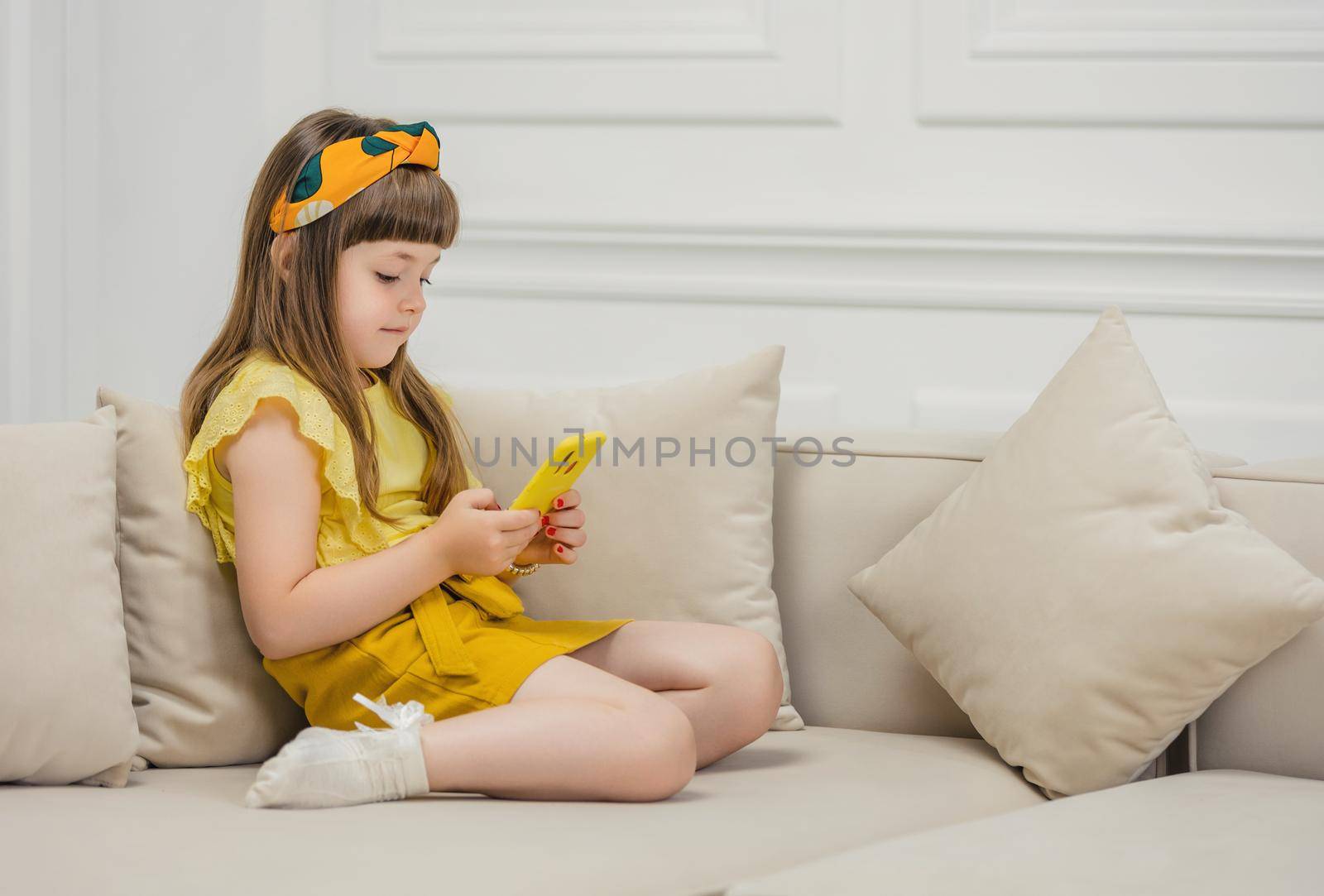 girl sitting with a phone in her hands