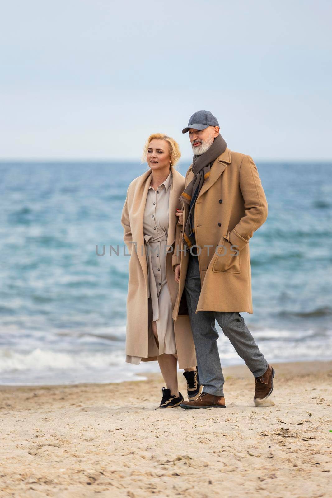 aged couple walking by the sea by zokov