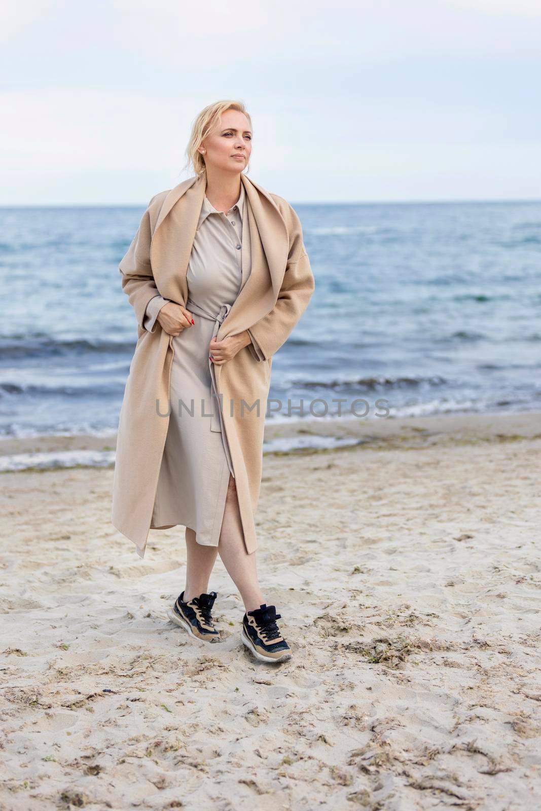 Woman in coat by the sea by zokov
