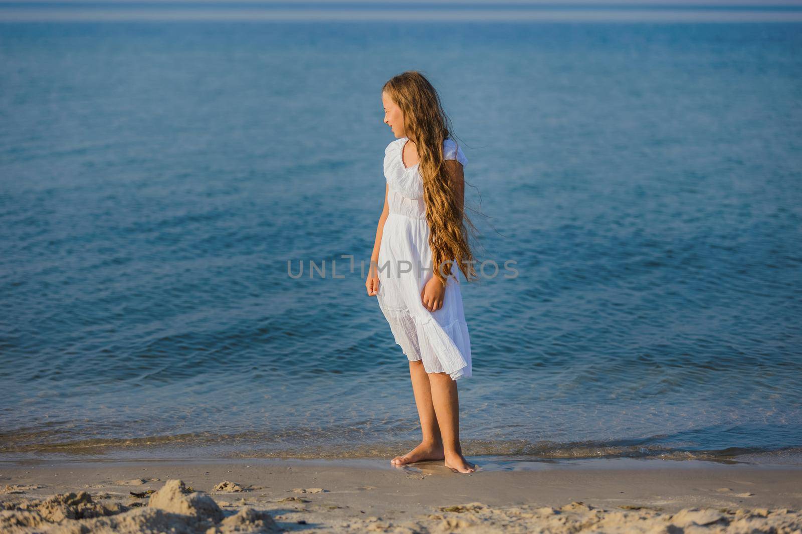 girl walking on the beach by zokov