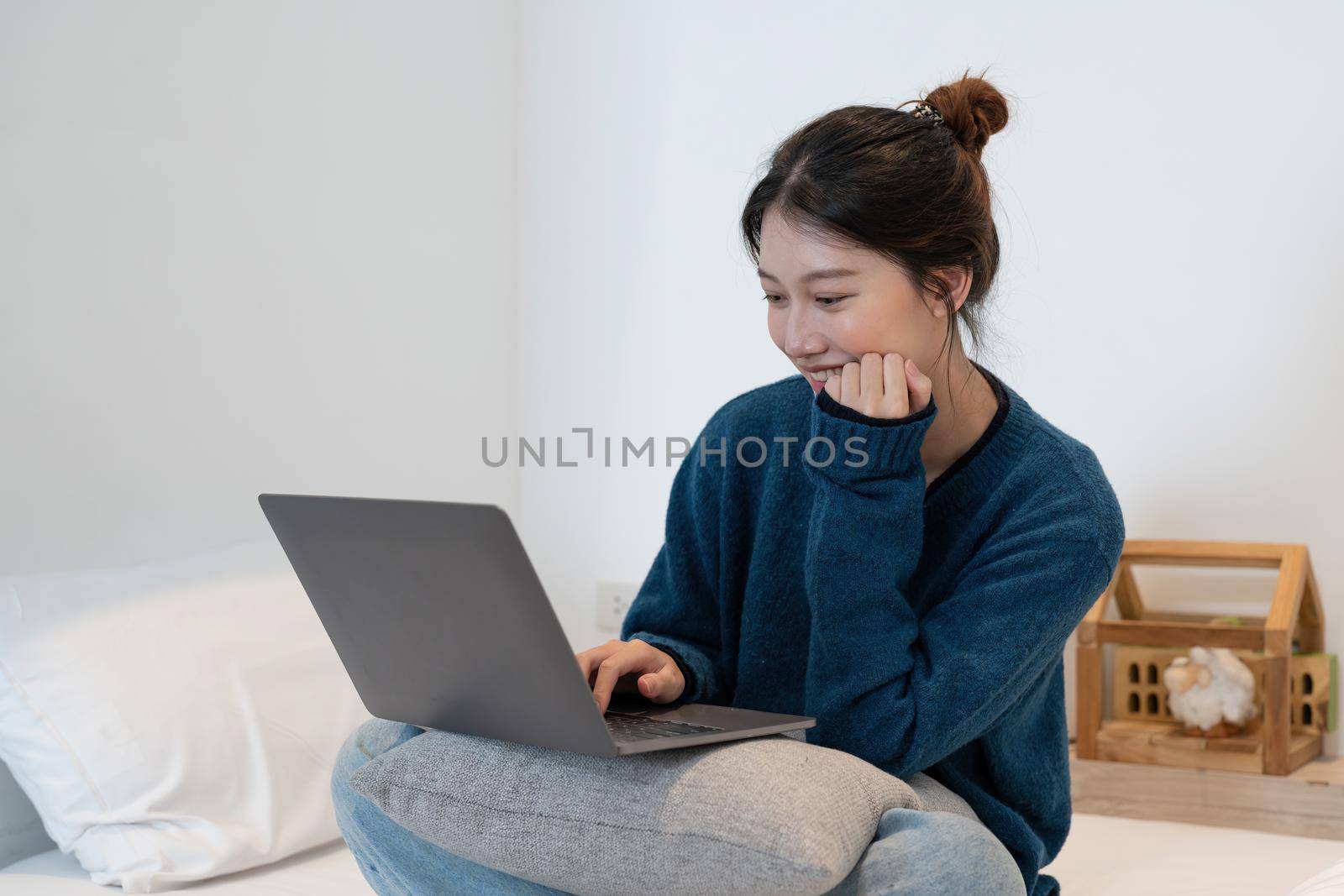 Young asian woman having conversation chatting while using laptop at house. Work at home, Video conference, Online meeting video call, Virtual meetings, Remote learning and E-learning by nateemee