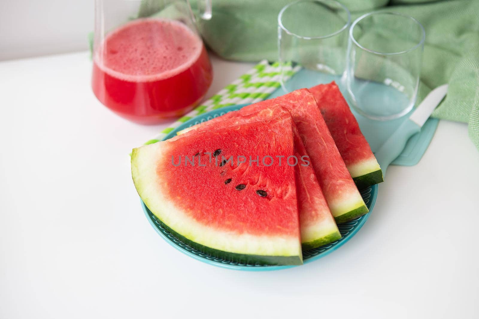 The process of making freshly squeezed juice from fresh watermelon, a healthy smoothie made from watermelon and mint leaves. A refreshing summer cocktail. by sfinks