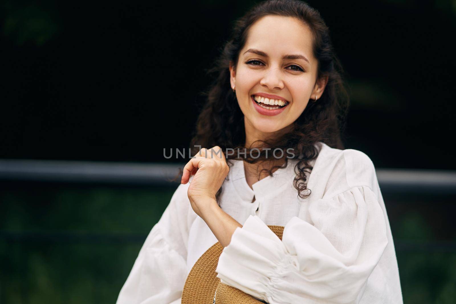 Young beautiful cheerful girl in a summer park. High quality photo