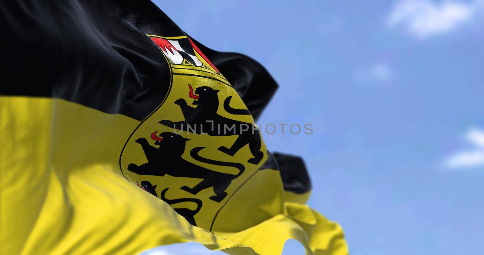 The flag of Baden-Württemberg waving in the wind on a clear day. Baden-Württemberg is a German state (Land) situated in southwestern Germany