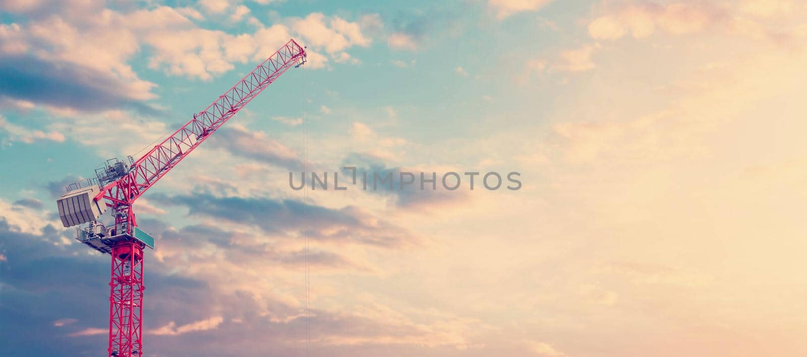 Tower crane on a dramatic sky background by Iryna_Melnyk